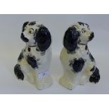 A pair of Staffordshire black and white chimney spaniels (2) 20cm high