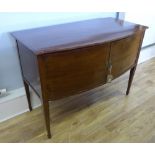 A 19th century inlaid mahogany bow front sideboard having a moulded top above panel doored cabinet