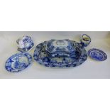 A quantity of Staffordshire blue and white pottery to include a large oval ashet, tureens, sauce