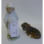 Royal Copenhagen model of a dachshund and another of a girl in a white cap and with a book under her