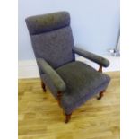 An Edwardian lounge chair having a mahogany frame with padded back support arm rests and seat raised