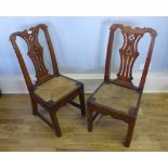 A pair of early 19th century chairs having  pierced splat backs above slip in rush seats raised on
