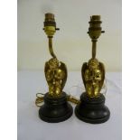 Pair of gilt metal table lamps in the form of kneeling angel on turned wooden bases