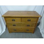 Art Nouveau style blonde oak chest of drawers, two over two with brass handles