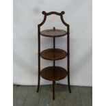 Mahogany three tier plate stand of customary form