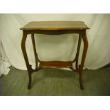 Mahogany two tier side table on four scroll legs