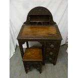 A late 19th century Anglo/Indian desk, profusely carved with matching stool