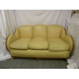 An Art Deco three piece leather and wood veneered lounge suite