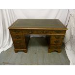 Late Victorian rectangular desk with tooled leather top and nine drawers on bracket feet