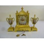 A 19th century French clock set, architectural form, gilt metal, two train movement, Roman