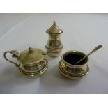 Silver three piece condiment set with blue glass liners, and two silver condiment spoons, Birmingham