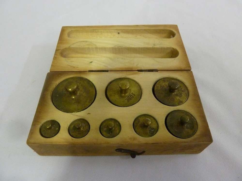 A cased set of brass weights