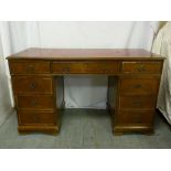 Mahogany partners desk with tooled leather top, nine drawers on bracket feet - A/F