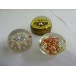 Three glass paperweights