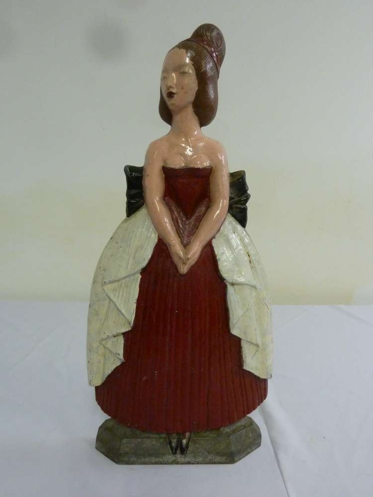 A painted metal fire guard in the form of a lady by the Birmingham guild