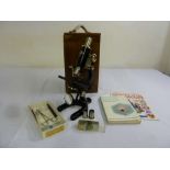 Prior of London mid 20th century microscope in fitted carrying case with additional lenses, slides