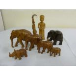 A quantity of carved hardwood elephants, a rhino and figures (8)