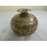 Persian white metal vase of bombe form, chased with flowers, masks, leaves and scrolls