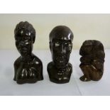 A pair of wooden carvings of African figures and a carved wooden figure of a man and  monkey