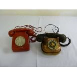 Two mid 20th century telephones one red plastic the other copper and brass