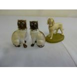 Pair of Siamese cat figurines and model of a dog