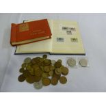 A quantity of British coins and two albums of stamps