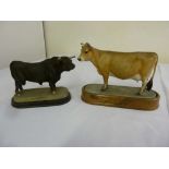 Royal Worcester Jersey cow on raised oval base (1961) and a black bull on raised oval base