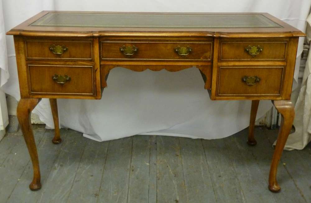 An early 20th century desk, tooled leather top, baluster legs, five drawers with brass handles