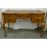 An early 20th century desk, tooled leather top, baluster legs, five drawers with brass handles