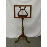 Mahogany music stand on baluster stand and three outswept feet