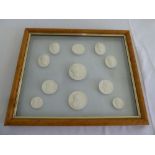 Eleven classical plaster casts in glazed maple wood frame