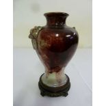 Chinese flame glazed baluster vase with stylised lion mask side handles on pierced carved hardwood