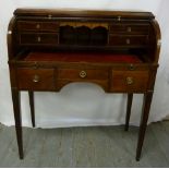 An Edwardian mahogany roll top desk with brass handles on four tapering rectangular legs