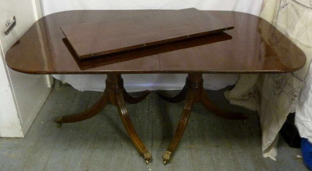 Mahogany dining table on two pedestal bases and one drop in leaf