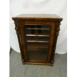 A Victorian inlaid music cabinet, the glazed hinged door flanked by turned baluster columns