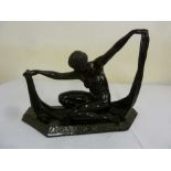 An Art Deco style figurine of an Egyptian dancing nymph signed to the shaped hexagonal base