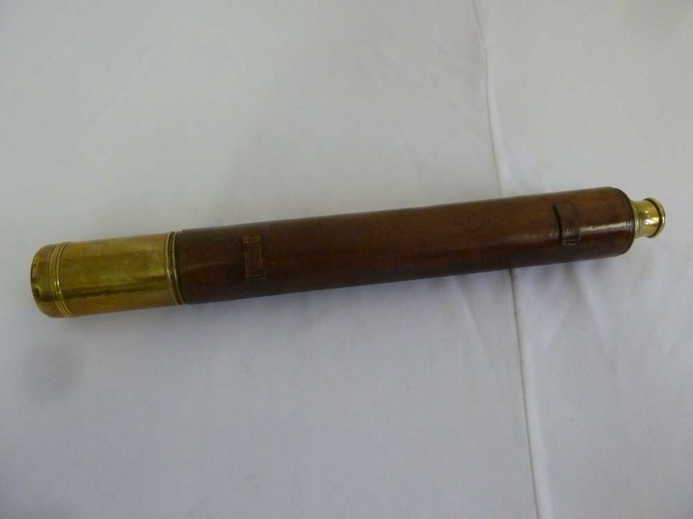 A single drawer brass telescope with leather cover by Nugent Wells with later inscription