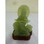 Chinese jadeite carving of a figure on a hardwood stand