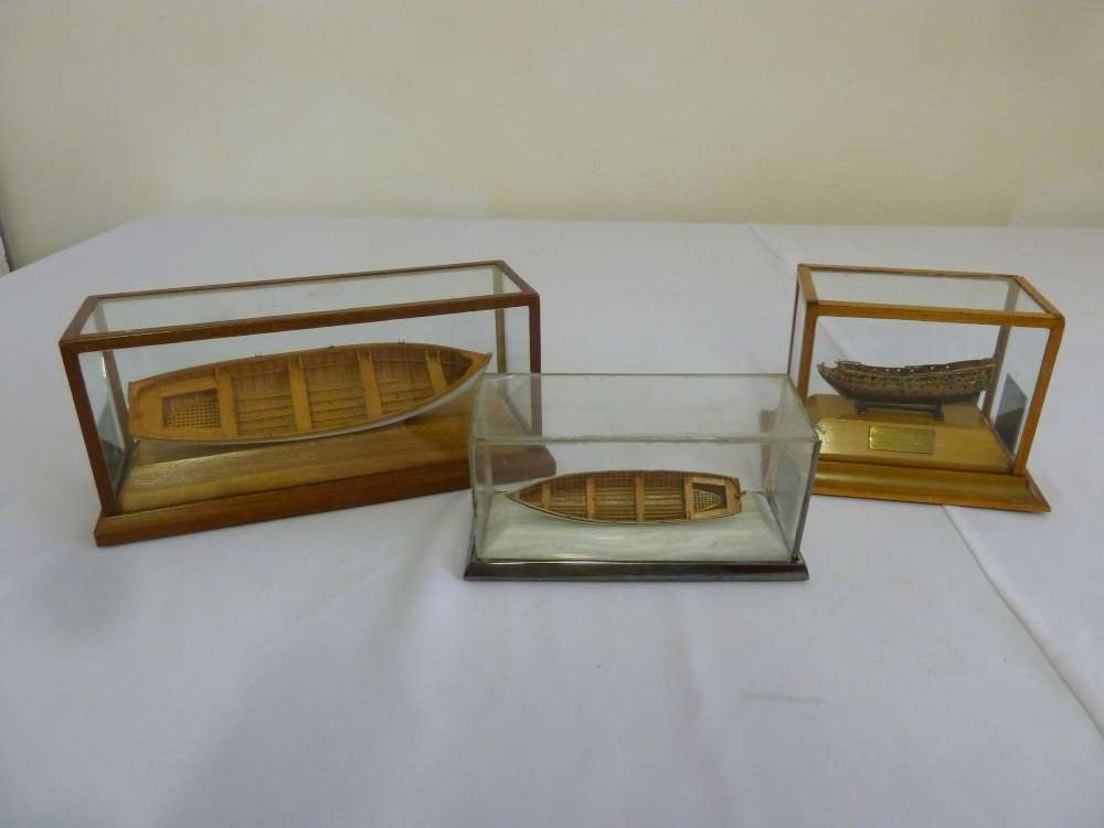 Three hand built small models of boats in glazed cases