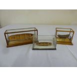 Three hand built small models of boats in glazed cases