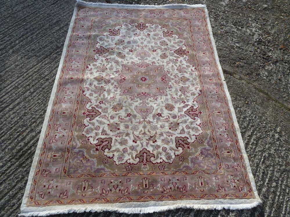 Oriental wool carpet ivory ground with medallion and pink repeating border - 181 x 131cm