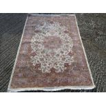 Oriental wool carpet ivory ground with medallion and pink repeating border - 181 x 131cm