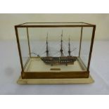 A scale wooden model of the USS Constitution in glazed wooden case A/F