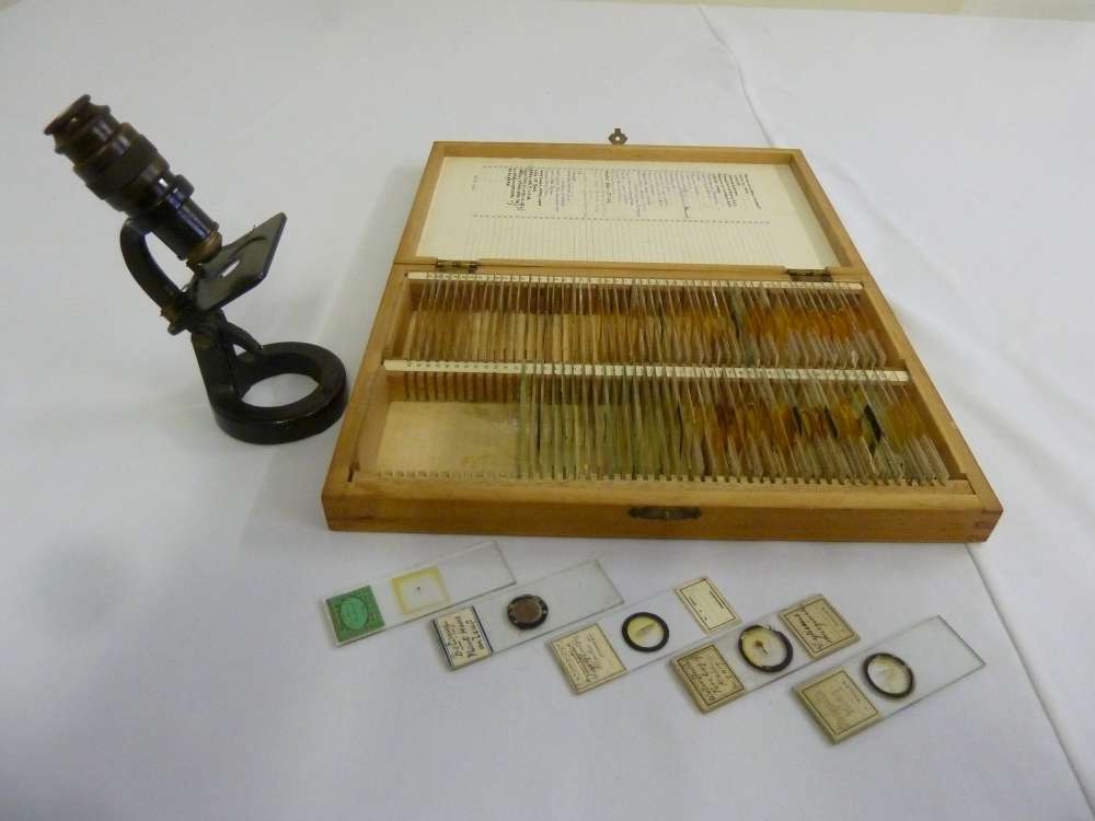 A quantity of miscellaneous prepared slides in fitted case and travel microscope by Baker