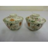 A pair of Famile Rose bowls and covers, decorated with birds, flowers and leaves