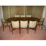 A Danish Rosewood dining suite comprising table and eight chairs to include two carvers, labels to