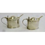 Pair of silver mustard pots oval with reeded borders and detachable blue glass liners, Chester 1938