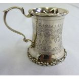 An Edwardian silver christening mug engraved to the sides with flowers and leaves and with double