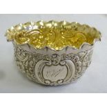 A silver bowl, circular chased with flowers and scrolls with gilt wash interior, London 1900 by