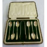 A cased set of six silver teaspoons with matching tongs